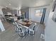 Eat-in kitchen boasts modern gray cabinets, stainless appliances and a dining area with a charming farmhouse table at 2530 Commercial Dr, Pahrump, NV 89048