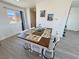 Dining area features an updated farmhouse table and plenty of natural light from the window at 2530 Commercial Dr, Pahrump, NV 89048