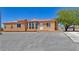 Inviting single-story home featuring desert landscaping, a clay tile roof, and a welcoming front entrance at 2530 Commercial Dr, Pahrump, NV 89048