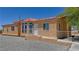 Cozy single-story home featuring desert landscaping, a clay tile roof, and a charming front porch at 2530 Commercial Dr, Pahrump, NV 89048