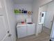 Bright laundry room features a washer, dryer, and storage shelf at 2530 Commercial Dr, Pahrump, NV 89048
