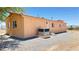 Rear view of home with desert landscaping and HVAC unit at 2530 Commercial Dr, Pahrump, NV 89048