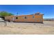 Rear view of home with desert landscaping and HVAC unit at 2530 Commercial Dr, Pahrump, NV 89048