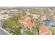 Expansive aerial view of a lakeside community, showcasing lush greenery and homes with tile roofs at 2608 Sun Reef Rd, Las Vegas, NV 89128