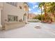 Spacious backyard with built-in grill area, fire pit, lush palm trees and rock waterfall feature at 2608 Sun Reef Rd, Las Vegas, NV 89128