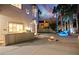 Backyard view with outdoor bar, tranquil fire pit, rock waterfall feature, and beautiful landscaping at 2608 Sun Reef Rd, Las Vegas, NV 89128