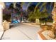 Lush outdoor entertaining space with patio, palm trees, and manicured landscaping at 2608 Sun Reef Rd, Las Vegas, NV 89128