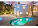 Beautiful backyard with a swimming pool, exterior elevation, and mature trees at 2608 Sun Reef Rd, Las Vegas, NV 89128