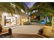 Beautiful outdoor space with a built-in grill, patio area, and lush tropical landscaping at 2608 Sun Reef Rd, Las Vegas, NV 89128