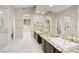 Elegant bathroom with dual vanities, granite countertops, and walk-in closets, complemented by marble floors at 2608 Sun Reef Rd, Las Vegas, NV 89128