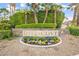 Ritz Cove community sign with stone base, landscaping, and decorative flowers at 2608 Sun Reef Rd, Las Vegas, NV 89128
