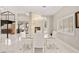 Bright dining area featuring modern chandelier, fireplace, floating stairs, and marble flooring at 2608 Sun Reef Rd, Las Vegas, NV 89128