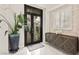 Elegant entryway features a decorative glass front door and stylish console table with modern accents at 2608 Sun Reef Rd, Las Vegas, NV 89128