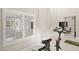 Comfortable exercise room featuring workout equipment, and a window with plantation shutters for privacy at 2608 Sun Reef Rd, Las Vegas, NV 89128