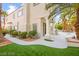 Home exterior featuring manicured landscaping, an outdoor barbecue, and covered patio at 2608 Sun Reef Rd, Las Vegas, NV 89128