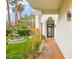 Welcoming home entrance with manicured landscaping, a water fountain, and an arched doorway at 2608 Sun Reef Rd, Las Vegas, NV 89128
