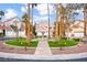 Beautifully landscaped front yard with lush greenery, a water fountain, and towering palm trees at 2608 Sun Reef Rd, Las Vegas, NV 89128