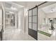 Hallway leading to an exercise room featuring a large sliding door, exercise bike and yoga mat at 2608 Sun Reef Rd, Las Vegas, NV 89128