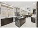 Gourmet kitchen with large island, stainless steel appliances, and ample counter space and dark cabinetry at 2608 Sun Reef Rd, Las Vegas, NV 89128