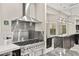 Chef's kitchen with a professional-grade gas range, stainless steel hood, and marble countertops at 2608 Sun Reef Rd, Las Vegas, NV 89128