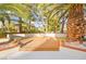 Inviting patio area surrounded by lush landscaping and mature palm trees creating a tranquil outdoor space at 2608 Sun Reef Rd, Las Vegas, NV 89128
