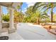 An open patio and outdoor landscaping with palm trees and built in barbecue at 2608 Sun Reef Rd, Las Vegas, NV 89128