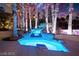 Luxurious backyard pool with a stone waterfall feature and accent lighting at 2608 Sun Reef Rd, Las Vegas, NV 89128
