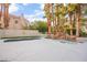 Backyard oasis showcasing a freeform pool, lush landscaping, waterfall feature and a serene outdoor experience at 2608 Sun Reef Rd, Las Vegas, NV 89128
