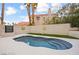 Inviting backyard pool with sunbathing area, mature landscaping, and secure fencing, perfect for relaxation at 2608 Sun Reef Rd, Las Vegas, NV 89128