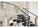 Modern staircase with metal railing and black stairs leading to the second floor at 2608 Sun Reef Rd, Las Vegas, NV 89128
