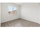 Bright bedroom with neutral carpet, white walls, and large window at 2721 Avril Point St, Las Vegas, NV 89156