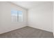 Bright bedroom with neutral carpet, white walls, and large window at 2721 Avril Point St, Las Vegas, NV 89156