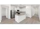 Modern kitchen features stainless steel appliances, white cabinets, and a center island at 2721 Avril Point St, Las Vegas, NV 89156