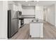 Bright kitchen featuring stainless steel appliances, white cabinets and an island sink at 2721 Avril Point St, Las Vegas, NV 89156