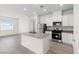 Bright, open kitchen featuring stainless steel appliances and a kitchen island at 2721 Avril Point St, Las Vegas, NV 89156