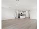 Open-concept living area with wood-look floors connecting the kitchen and living space at 2721 Avril Point St, Las Vegas, NV 89156