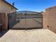 Backyard featuring a metal gate, gravel, and privacy fencing at 2772 Brinkley Manor St, Laughlin, NV 89029