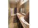 Bathroom featuring double sinks, granite counters, and a shower-tub combo at 2772 Brinkley Manor St, Laughlin, NV 89029