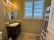 Well-lit bathroom with granite countertop, a sink, a mirror, and a shower-tub at 2772 Brinkley Manor St, Laughlin, NV 89029
