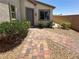 Inviting walkway leading to the front door, complemented by lush greenery and desert landscaping for a warm welcome at 2772 Brinkley Manor St, Laughlin, NV 89029