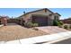 Charming single-story home featuring a two-car garage, desert landscaping, and gated front entry for added privacy at 2772 Brinkley Manor St, Laughlin, NV 89029