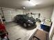 Spacious garage features a vehicle, overhead storage, and ample room for tools and equipment at 2772 Brinkley Manor St, Laughlin, NV 89029