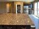 Granite island complements this kitchen with a pantry and stainless steel appliances at 2772 Brinkley Manor St, Laughlin, NV 89029