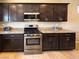 Well-equipped kitchen with stainless steel appliances and dark cabinets at 2772 Brinkley Manor St, Laughlin, NV 89029