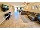 Spacious living room with tile flooring, neutral decor, and abundant natural light, ideal for relaxation and entertaining at 2772 Brinkley Manor St, Laughlin, NV 89029