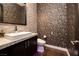 Stylish powder room features a modern sink, vanity, and designer wallpaper for an elegant touch at 29 Costa Tropical Dr, Henderson, NV 89011