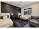 Cozy bedroom featuring two twin beds, a dark accent wall, and a window with mountain views at 29 Costa Tropical Dr, Henderson, NV 89011