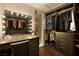Walk-in closet with vanity and Hollywood mirror, custom shelving and clothing racks providing storage space at 29 Costa Tropical Dr, Henderson, NV 89011