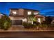Charming two-story home with a beautifully landscaped front yard and manicured palm trees at 29 Costa Tropical Dr, Henderson, NV 89011