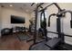 Home gym equipped with modern exercise equipment and a TV for a complete workout experience at 29 Costa Tropical Dr, Henderson, NV 89011